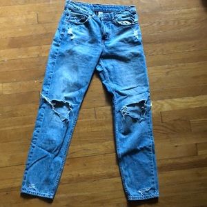 Blue mom jeans with rips at knees